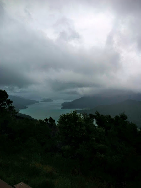 the water is still beautiful under grey skies